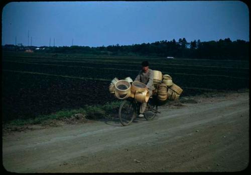 Man on bicycle with baskets