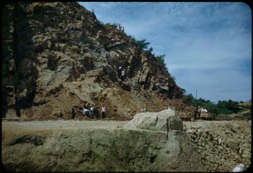 Group of people next to rocky cliff