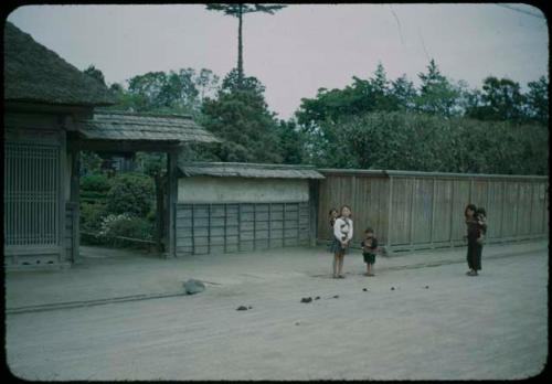 People standing in front of house