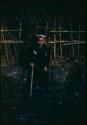 Man standing in front of fence