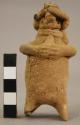 Rattle with suspension hole at back of neck.  Human effigy with flute