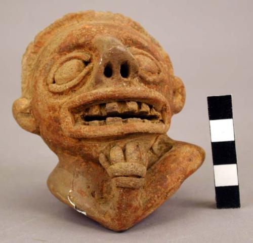 Rattle human effigy head with one hand holding up chin.  Red incised pottery