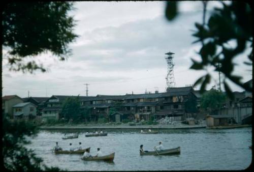 Boats, with shoreline in background