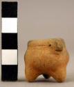 Miniature red incised tripod with stylized animal head