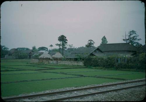 Railroad track, with houses in background