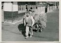 Man pulling cart of rice