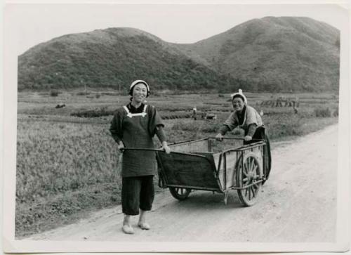 Two women with a cart