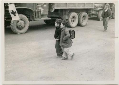 Schoolboys in front of Army truck