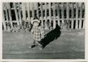 Child standing in front of fence