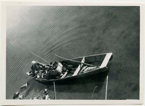 Man in boat shucking oysters