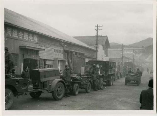 Motor march, with jeep, truck and ambulance