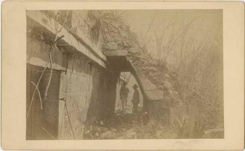 Stone wall with buttress and two men