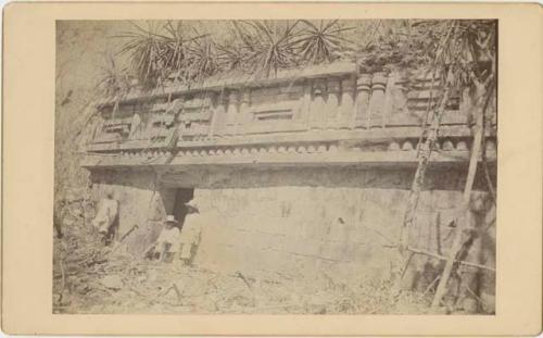 Wall facade with three local men