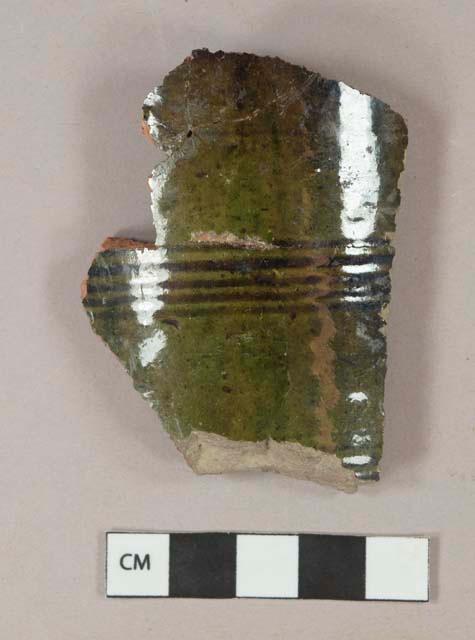 Dark green lead glazed redware vessel body fragment