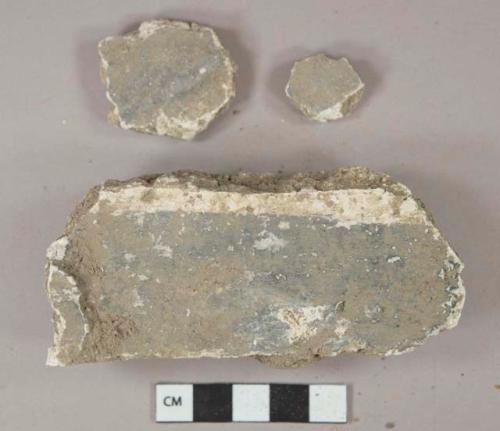 Dark blue painted white plaster fragments