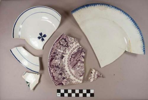 Blue on white handpainted pearlware saucer fragments, white paste; Black and green handpainted polychrome rim fragment, white paste; purple transferprinted pearlware saucer or muffin fragments, white paste; Blue on white shell-edged pearlware plate fragment, white paste