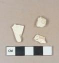 Undecorated creamware vessel body fragments; 1 white undecorated kaolin pipe bowl fragment