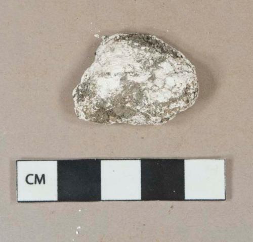 White shell fragment, heavily degraded, likely oyster