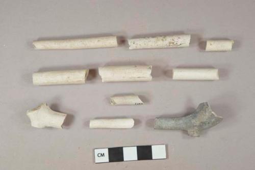 White undecorated kaolin pipe stem and bowl framgents, 1 heavily burned, 1 stamped on foot, 3 fragments with 4/64" bore diameter, 1 fragment with 6/64" bore diameter, 2 fragment with 7/64" bore diameter, 4 fragment with 8/64" bore diameter