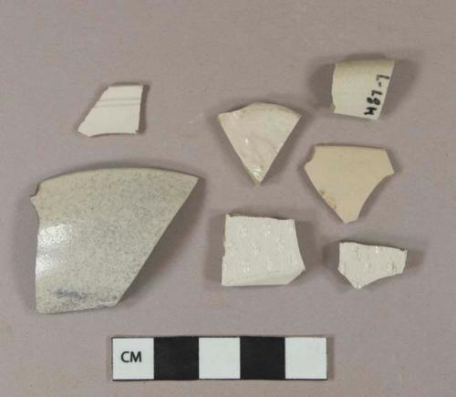 White salt-glazed stoneware vessel rim fragments, 1 body fragment, 2 fragments molded with "barley" pattern, 1 with floral molded decoration, light gray paste