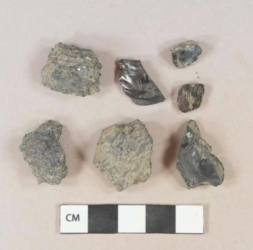 Burned coal fragments, 1 charcoal fragment