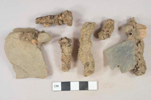 Ferrous metal nail fragments, heavily corroded, 2 adhered to mudstone fragments