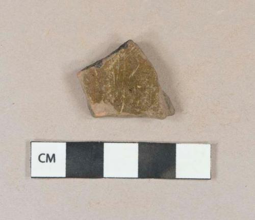 Brown lead glazed redware vessel body fragment, burned