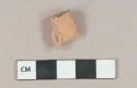 Unglazed redware figurine fragment, hand holding book