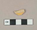 Undecorated lead glazed yellow ware vessel body fragment, buff paste