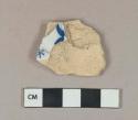 Blue on white handpainted tin-glazed earthenware vessel body fragment, buff paste, burned