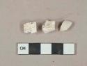 White kaolin pipe bowl fragments, 1 with foot fragment