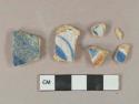 Blue and tan on white handpainted tin-glazed earthenware vessel body fragments, buff paste