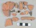 Brown lead glazed redware vessel body and rim fragments; red brick fragments