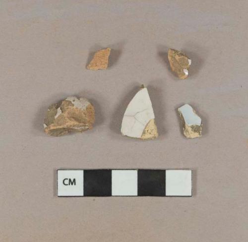 Four undecorated tin glazed earthenware body sherds, two red-bodied and one without glaze; one undecorated red-bodied tin glazed earthenware base sherd