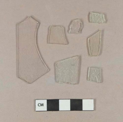 Two colorless flat glass fragments; five aqua flat glass fragments