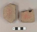 Redware roof tile fragments, one with partial nail hole