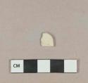 Cream-colored plastic fragment