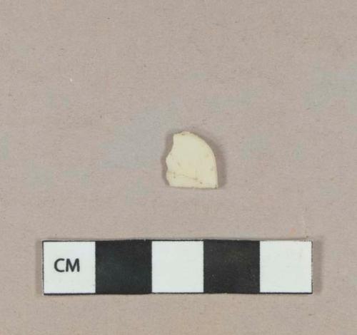 Cream-colored plastic fragment