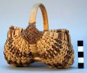 Basket - made in shape of 2 lobes, with handle--brown and neutral color
