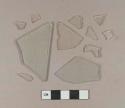 Ten aqua flat glass fragments; one colorless bottle glass fragment