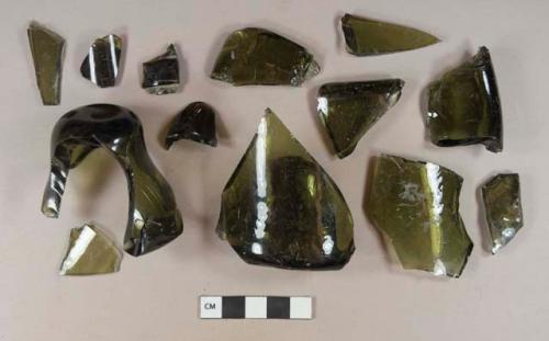 Olive green bottle glass base body and neck fragments, some hand-blown; one possible turn-mold base, one sand pontil base; two neck fragments with applied finish