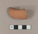 Unglazed undecorated redware handle sherd