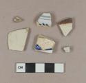 Undecorated pearlware body sherd; undecorated body sherd; blue hand painted whiteware body sherd; blue hand painted tin glazed earthenware body sherd; undecorated tin glazed earthenware body sherd; brown on white Bristol glazed stoneware body sherd