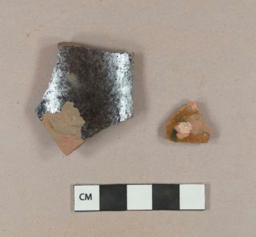 Slip decorated lead glazed redware body sherd; undecorated lead glazed redware body sherd