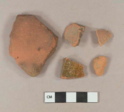 Brick fragments; unglazed, undecorated redware body sherd; undecorated lead glazed redware body sherd