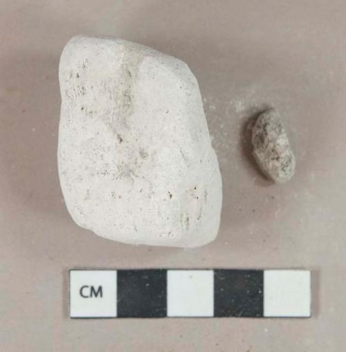 White plaster fragments, heavily degraded