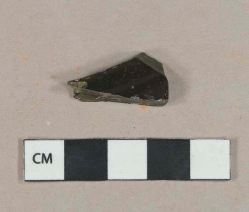 Dark olive green vessel body fragment, likely bottle