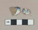 Blue shell-edged pearlware vessel rim fragment, 1 blue on white handpainted pearlware vessel body fragment, white paste