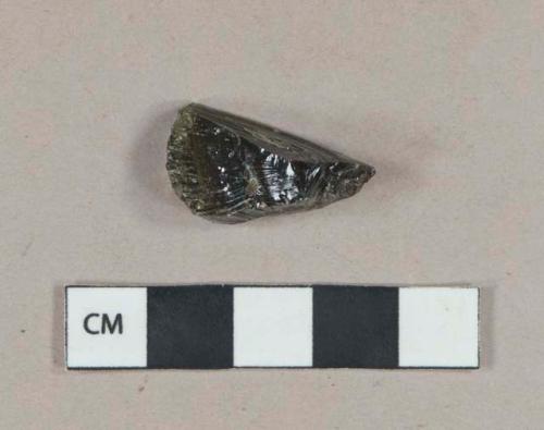 Olive green vessel glass fragment, likely bottle glass