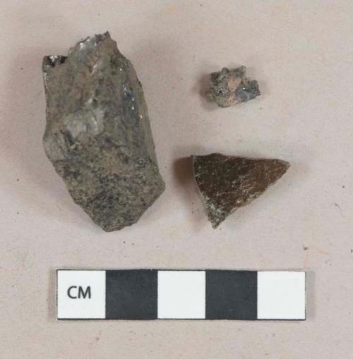 Coal fragment; slag fragment; Dark brown lead glazed redware, gray and red paste